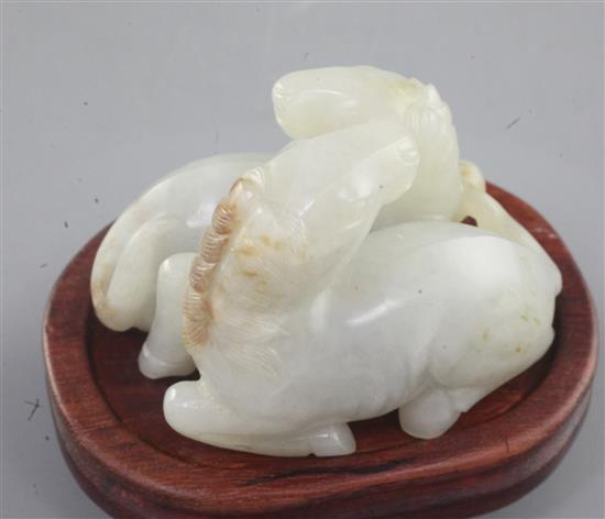 A Chinese pale celadon and russet jade group of two horses, length 6cm